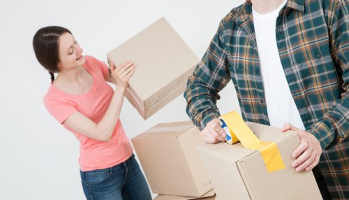 Careful wrapping of fragile belongings during a move in Brixton