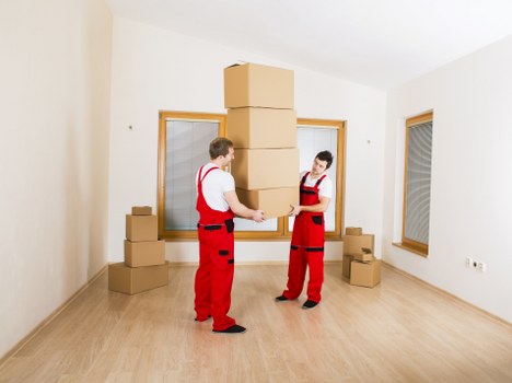 Removal team loading boxes and furniture from a Brixton flat
